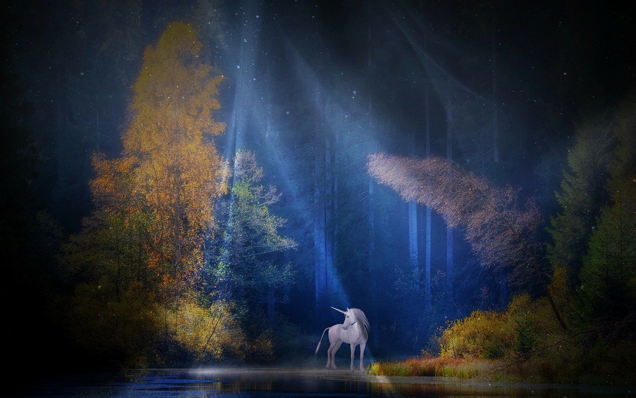 Unicorn standing in a moonbeam in the forest.