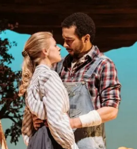 A staged production of Holes with the actors playing Kate and Sam embracing.