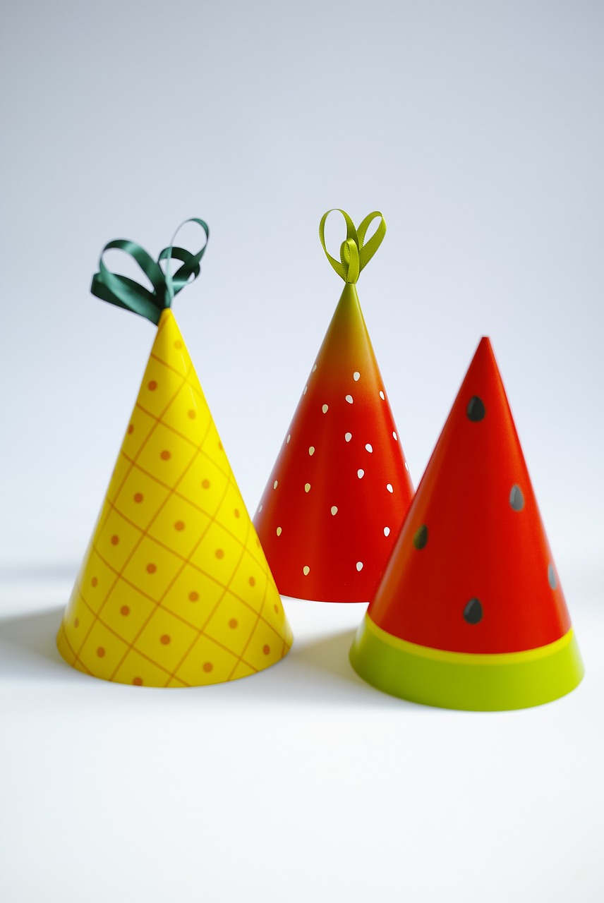Three party hats, fruit themed.