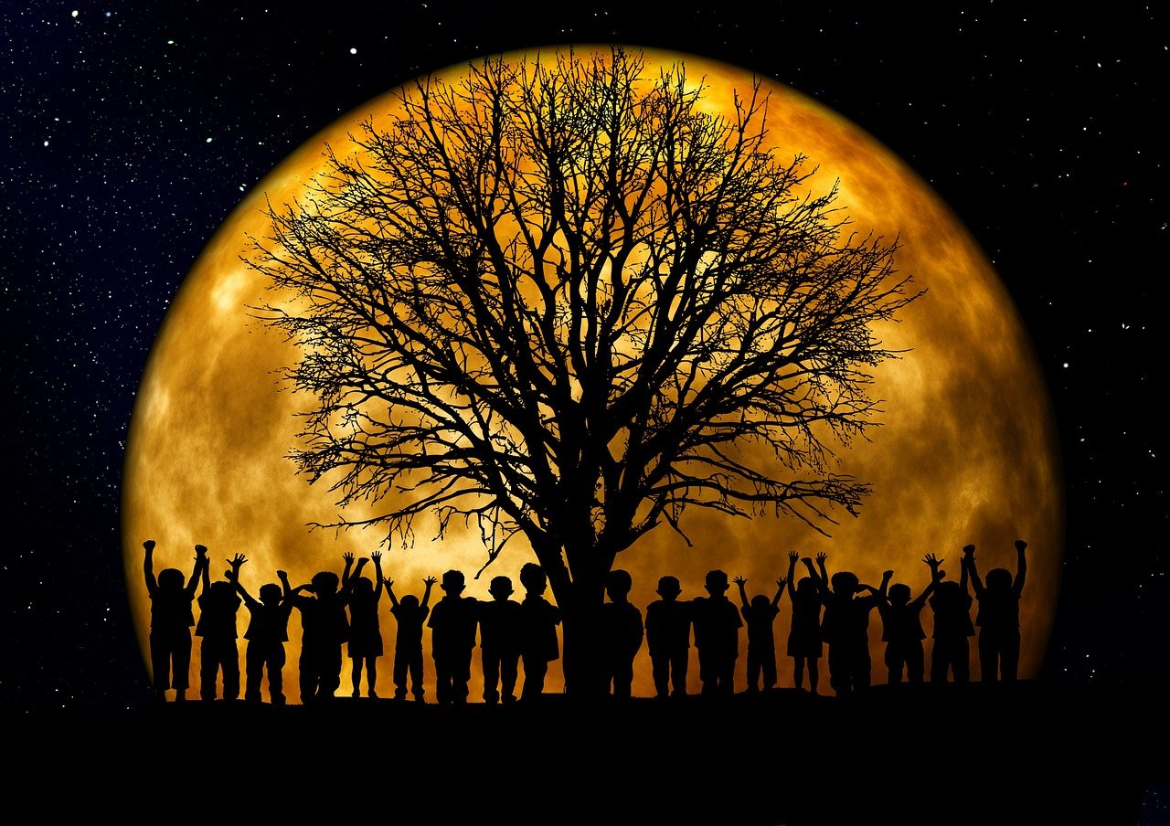 Fantastical moon rising behind a tree and a group of children.