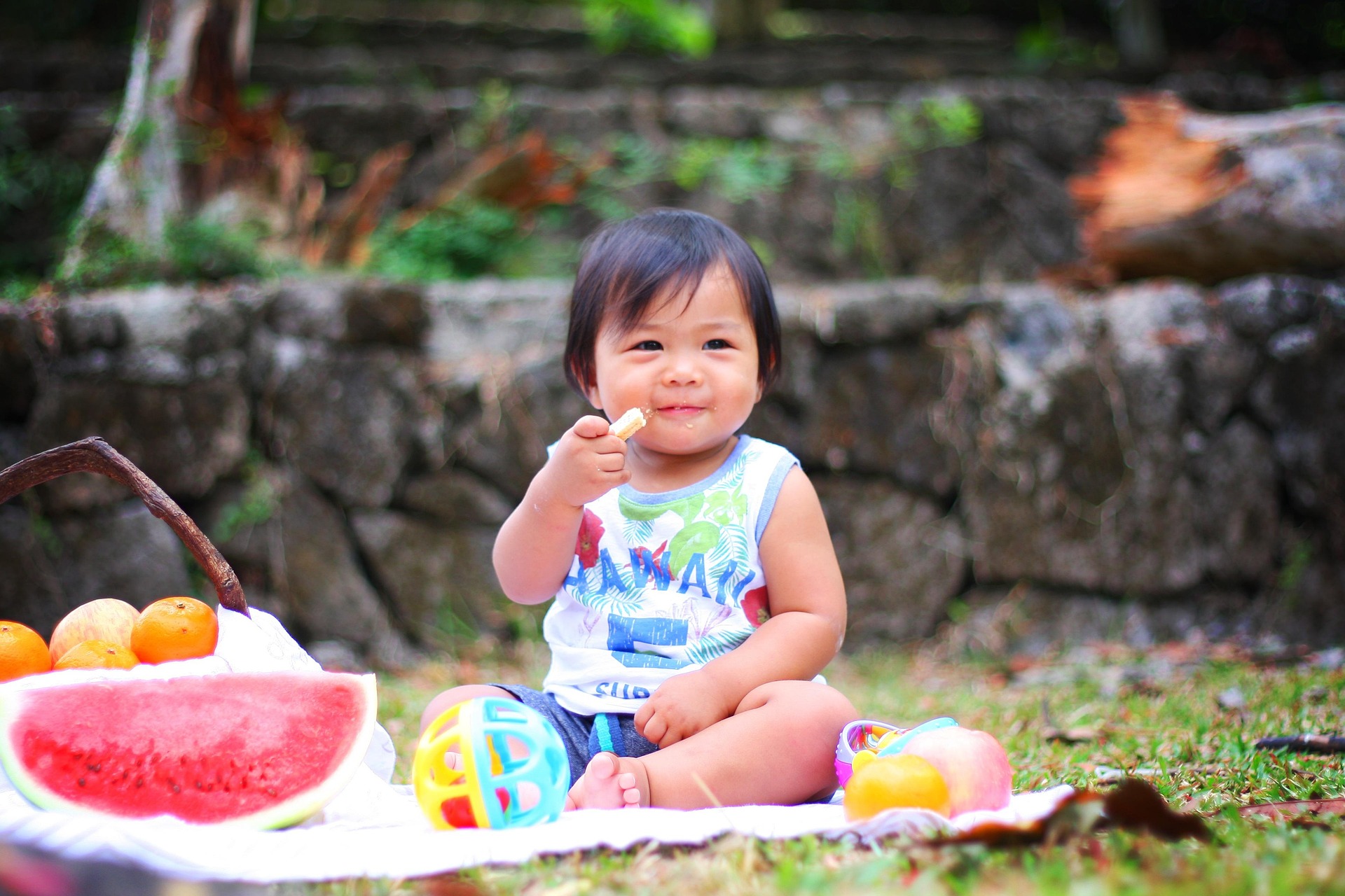 A small child enjoying a picnic outdoors.