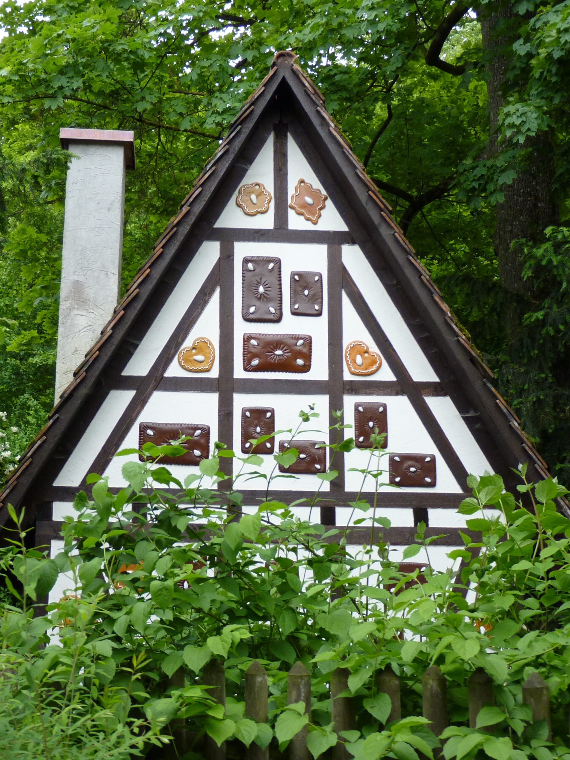 A cottage with cookies and sweets on the walls. Must be a witch trying to tempt children.