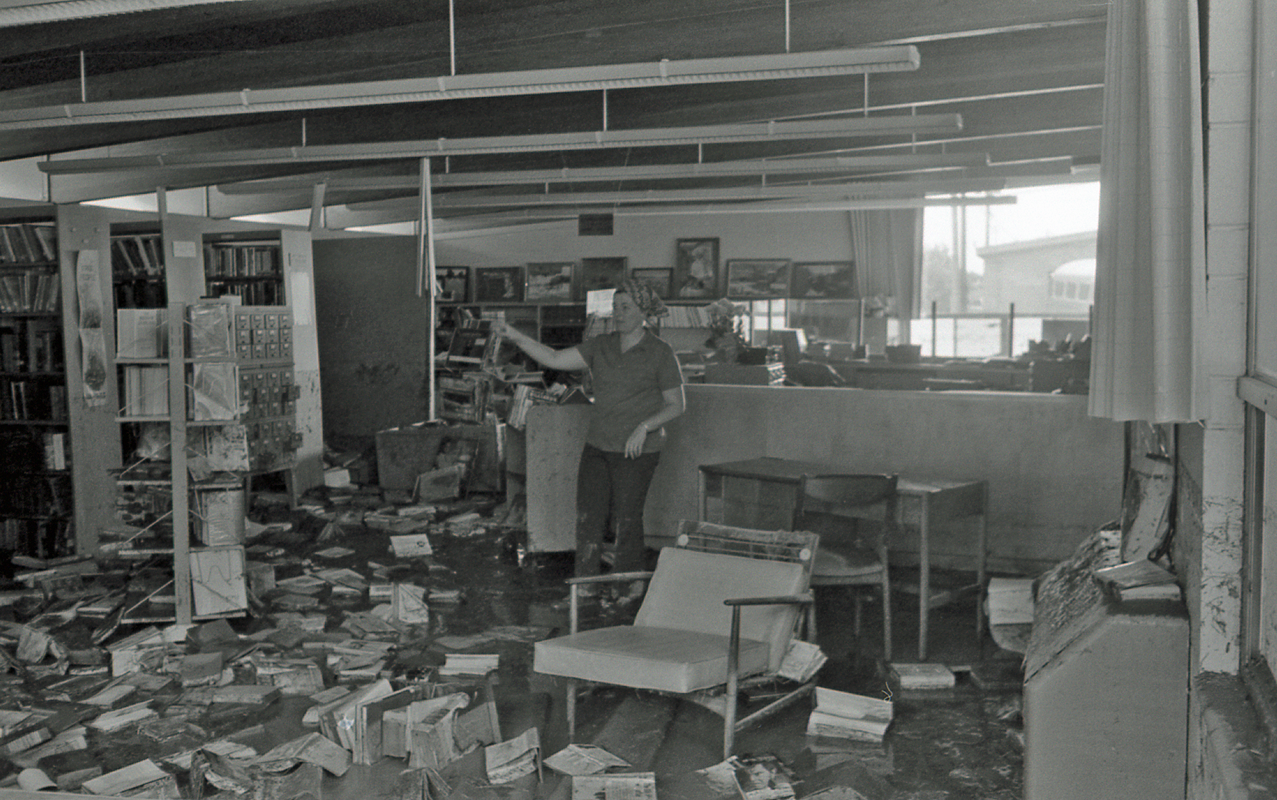 Looking East with Cheryl Reeser in front of the circulation desk